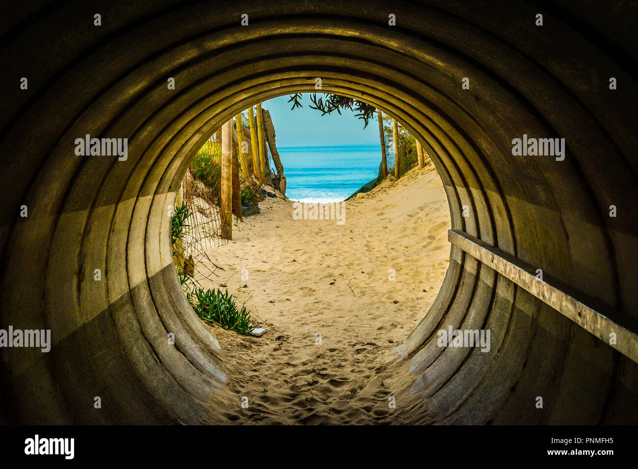 A tunnel leading to a beach in Portugal Stock Photo Alamy