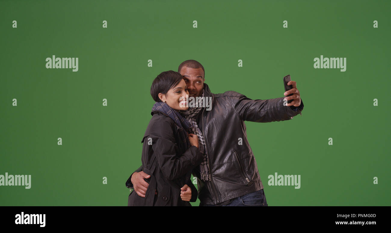 A black couple poses for a picture on green screen Stock Photo Alamy