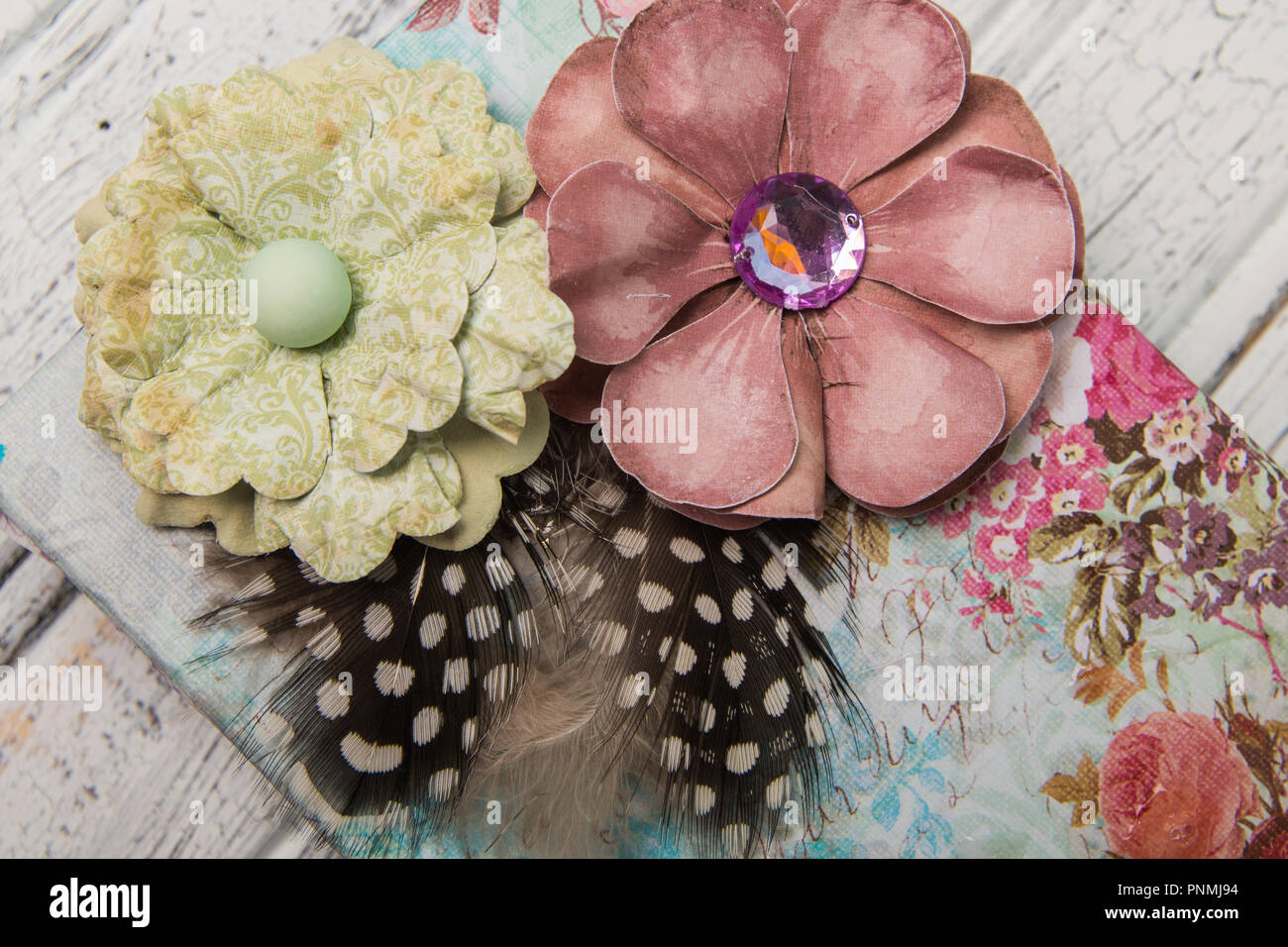 Shabby chic gift box with flowers and feathers Stock Photo