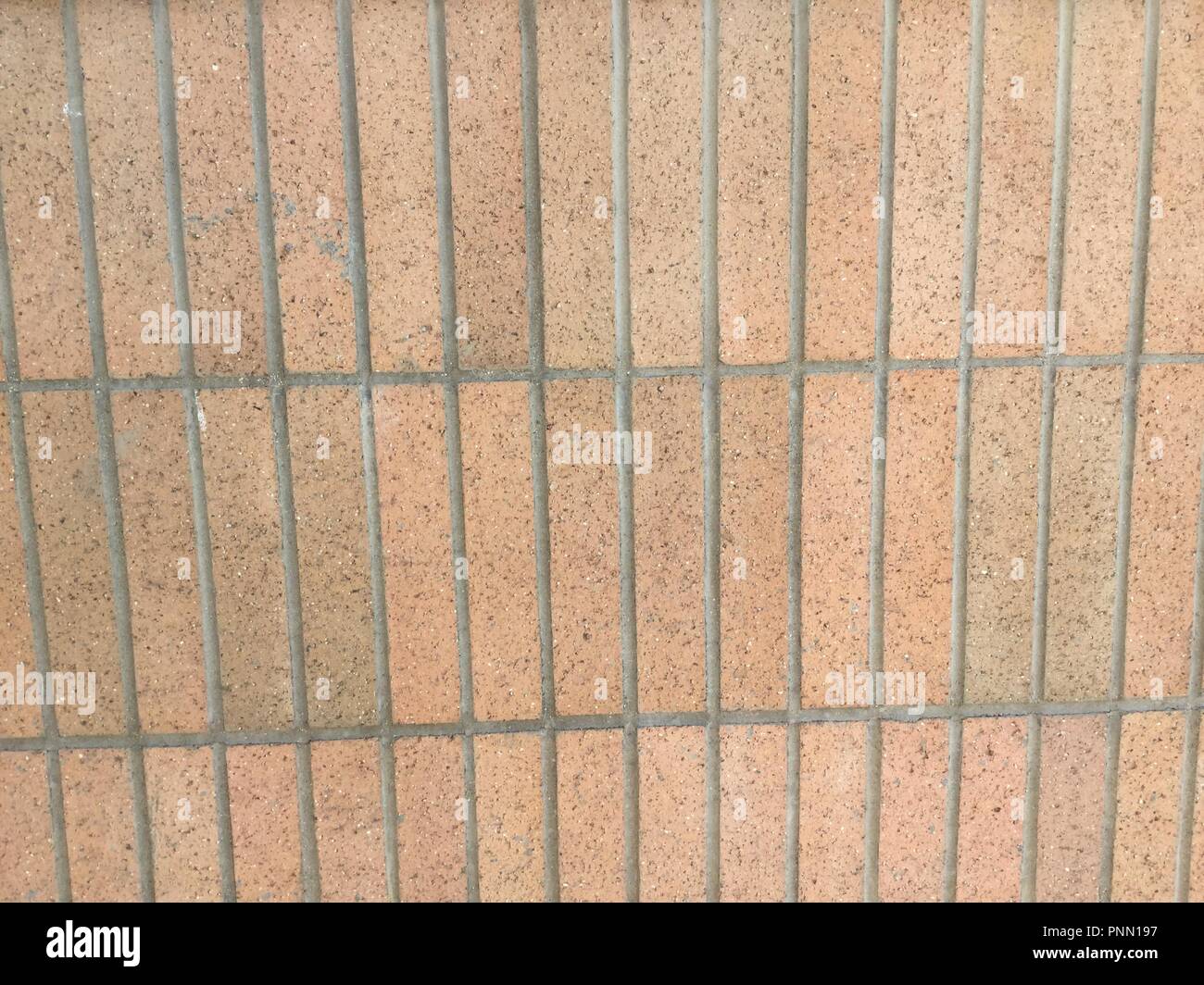 Long thin vertical bricks forming a brick wall. Stock Photo