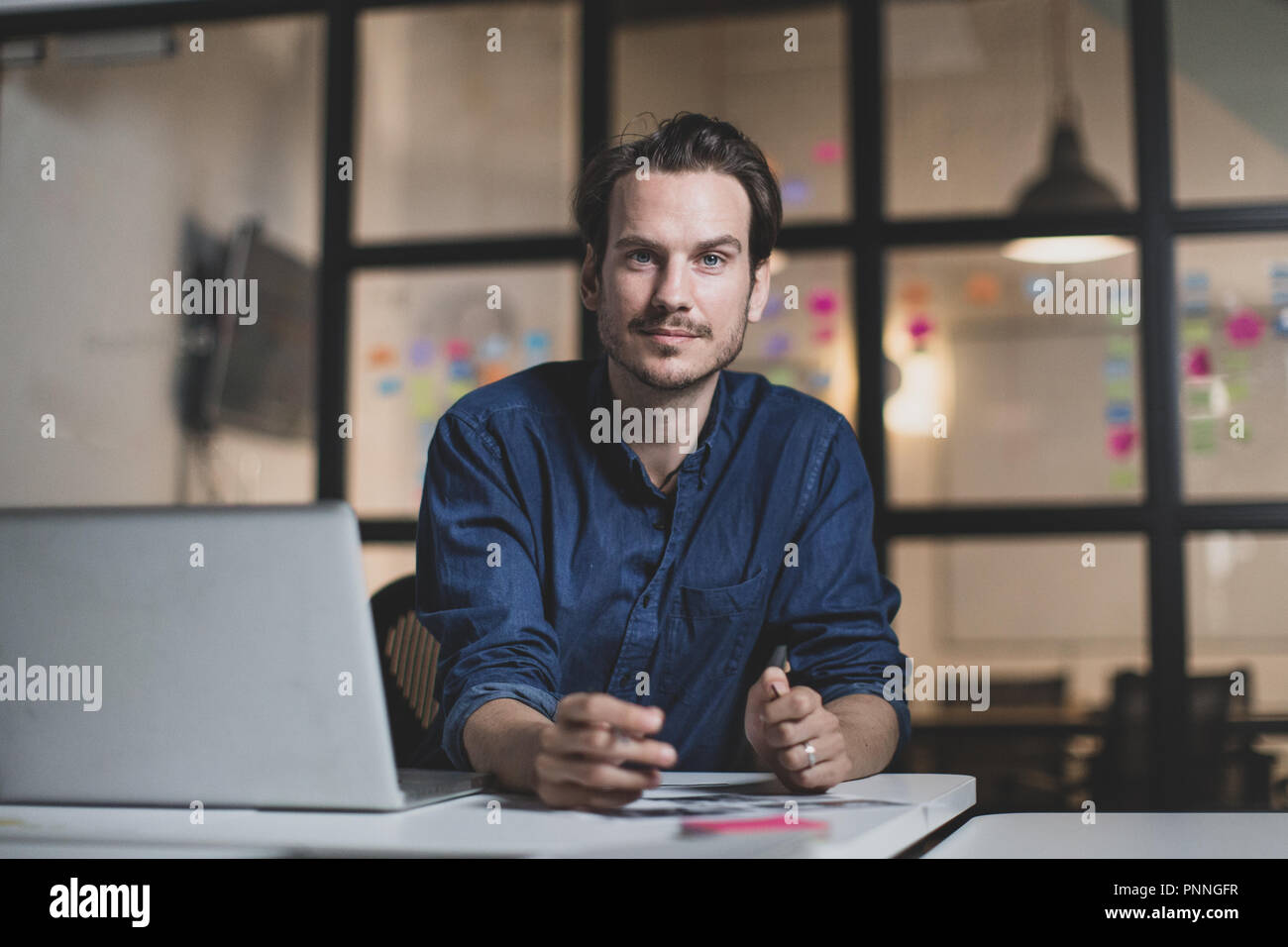 Portrait adult male working late in an office Stock Photo