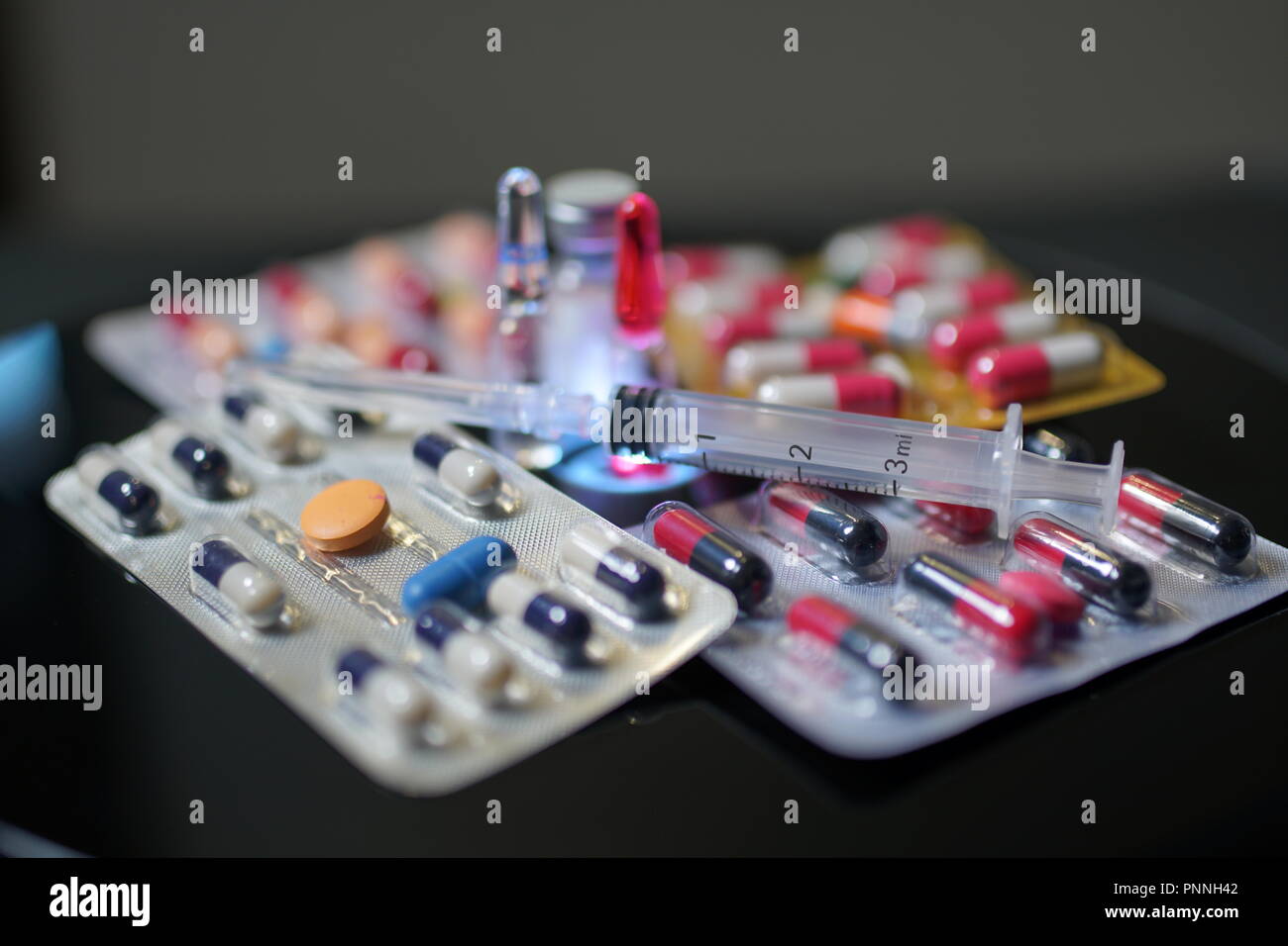 Pills and drugs. Medicine, capsules in blister, tablets, injection, syringe and needle. Closeup
