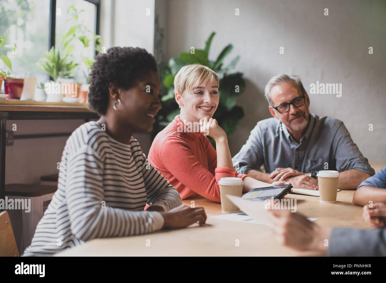 Group of coworkers having a meeting in a cafe Stock Photo