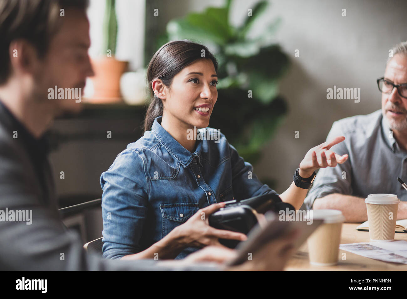 Coworkers discussing VR headset technology Stock Photo