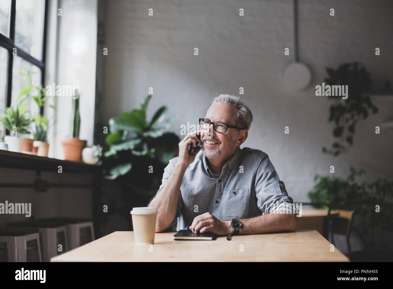 Mature businessman working in a cafe Stock Photo
