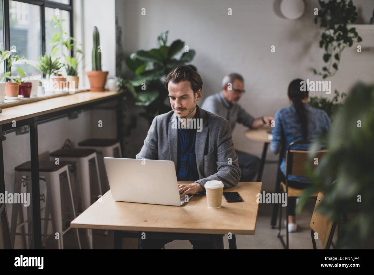 Freelance businessman working in a cafe Stock Photo