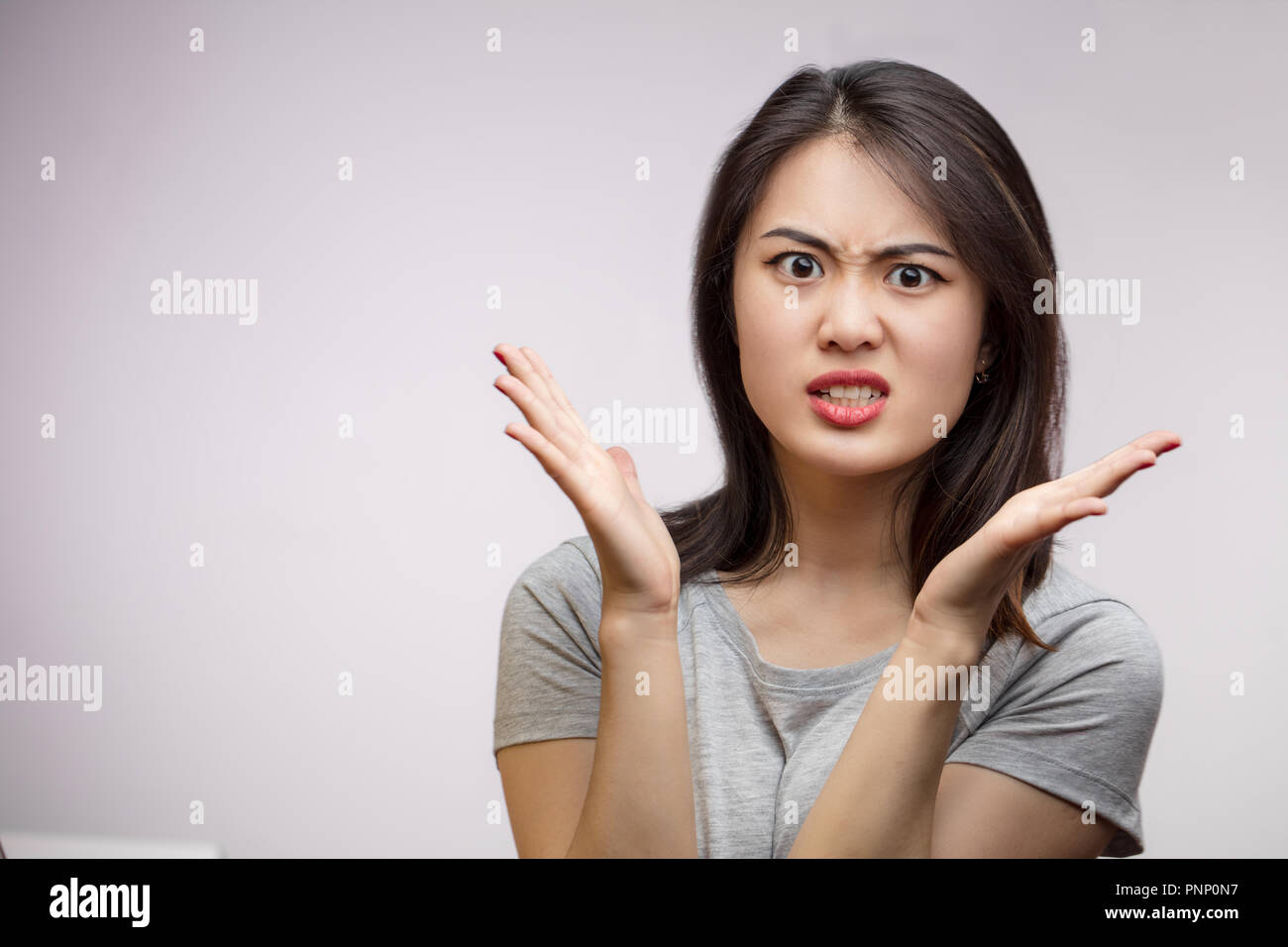 Frustrated Angry Asian woman isolated over white background image