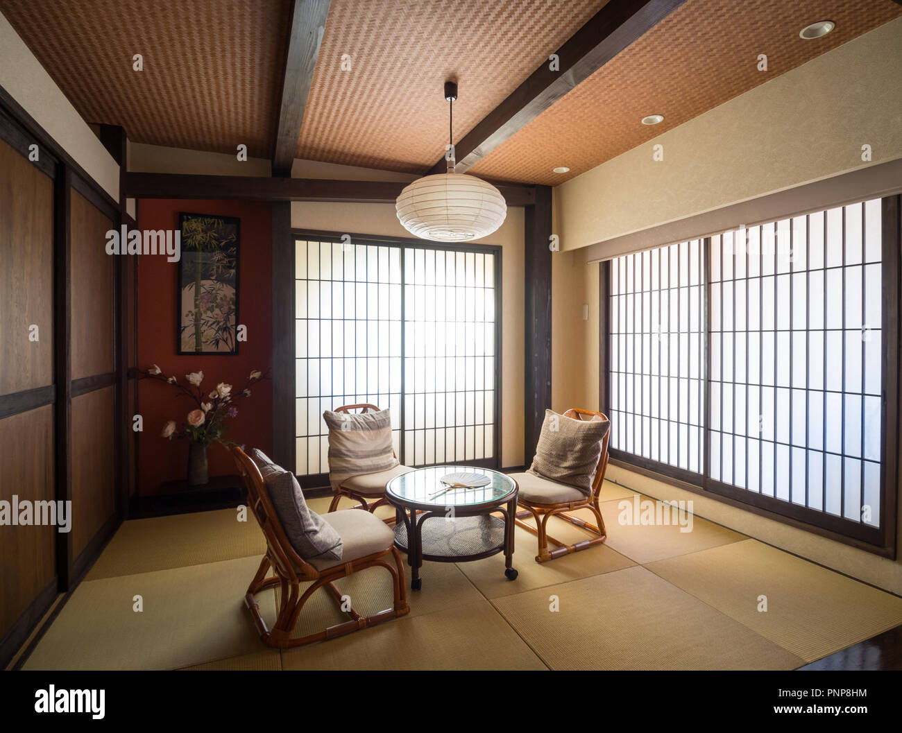 A modern Japanese-style room (washitsu, tatami room), with shoji screen doors (Japanese paper doors) and tatami mats. Shibuya, Tokyo, Japan. Stock Photo