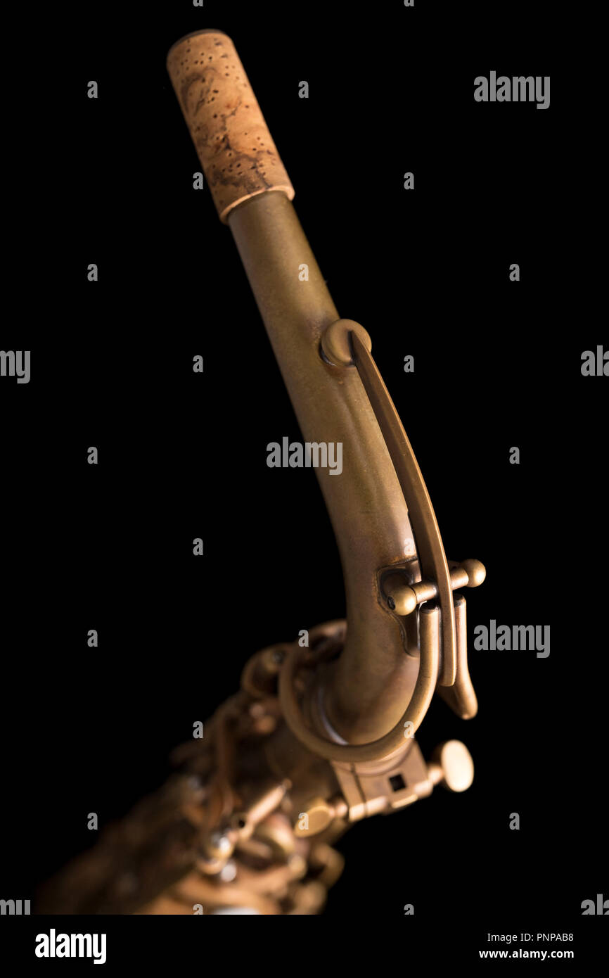 Matte finish saxophone neck, pipe line on black background Stock Photo