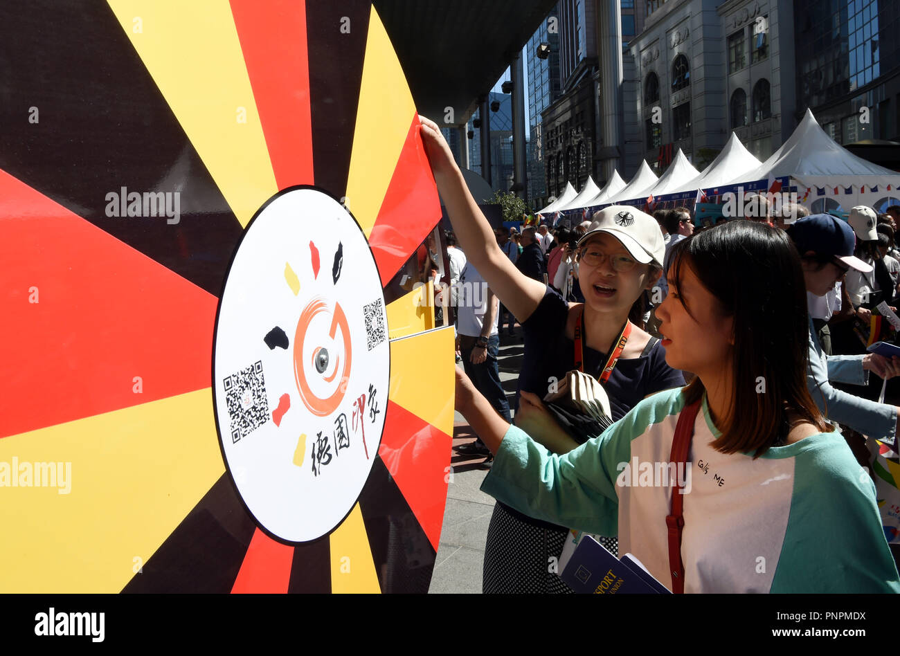 Beijing, China. 22nd Sep, 2018. A visitor turns a turntable in front of the Germany booth during the 'European-Style Street' cultural event held in Beijing, capital of China, Sept. 22, 2018. Exhibitors from the EU member countries present their various cultures during the event sponsored by the EU delegation to China. Credit: Ma Ning/Xinhua/Alamy Live News Stock Photo