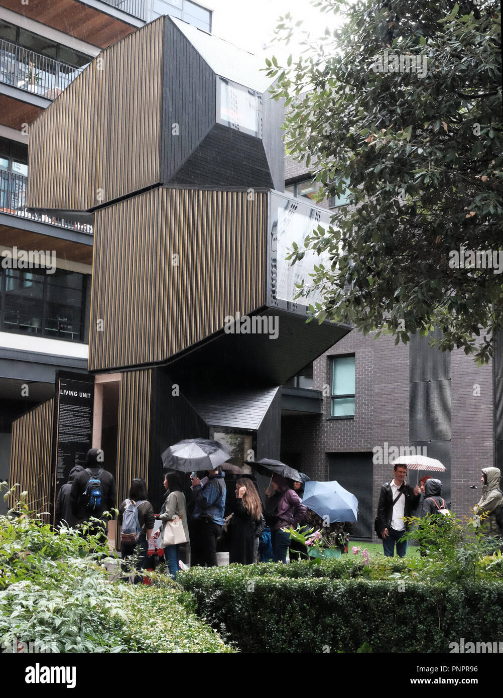 1 Old Street Yard, Old Street, London, England 22nd Sept. 2018 UK Weather Queuing in the rain to view the Living Unit London installation as part of Open House London 2018. This adaptable design comprises three modular pods, offering insight into innovative space-saving design solutions OFIS Architects, 2017. At White Collar Factory. Credit: Judi Saunders/Alamy Live News Stock Photo