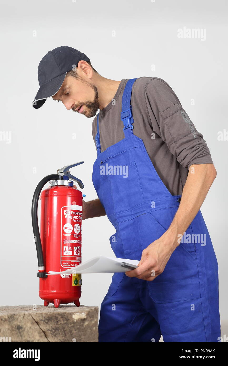 A Fire extinguisher check by a professional Stock Photo