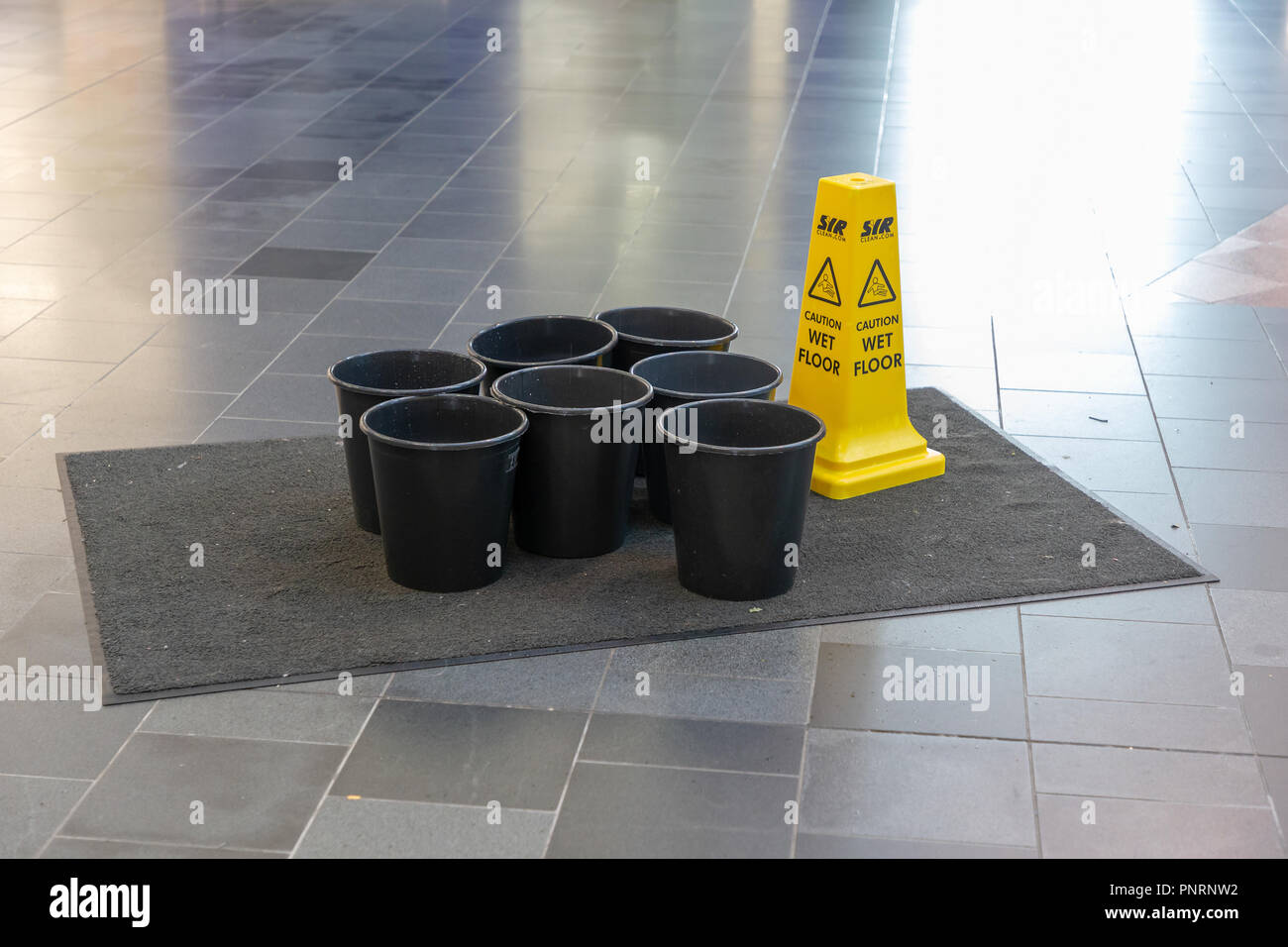 With the strong winds and torrential rain of Storm Bronagh many buildings have developed leaks in the roof and buckets are used to catch the water Stock Photo