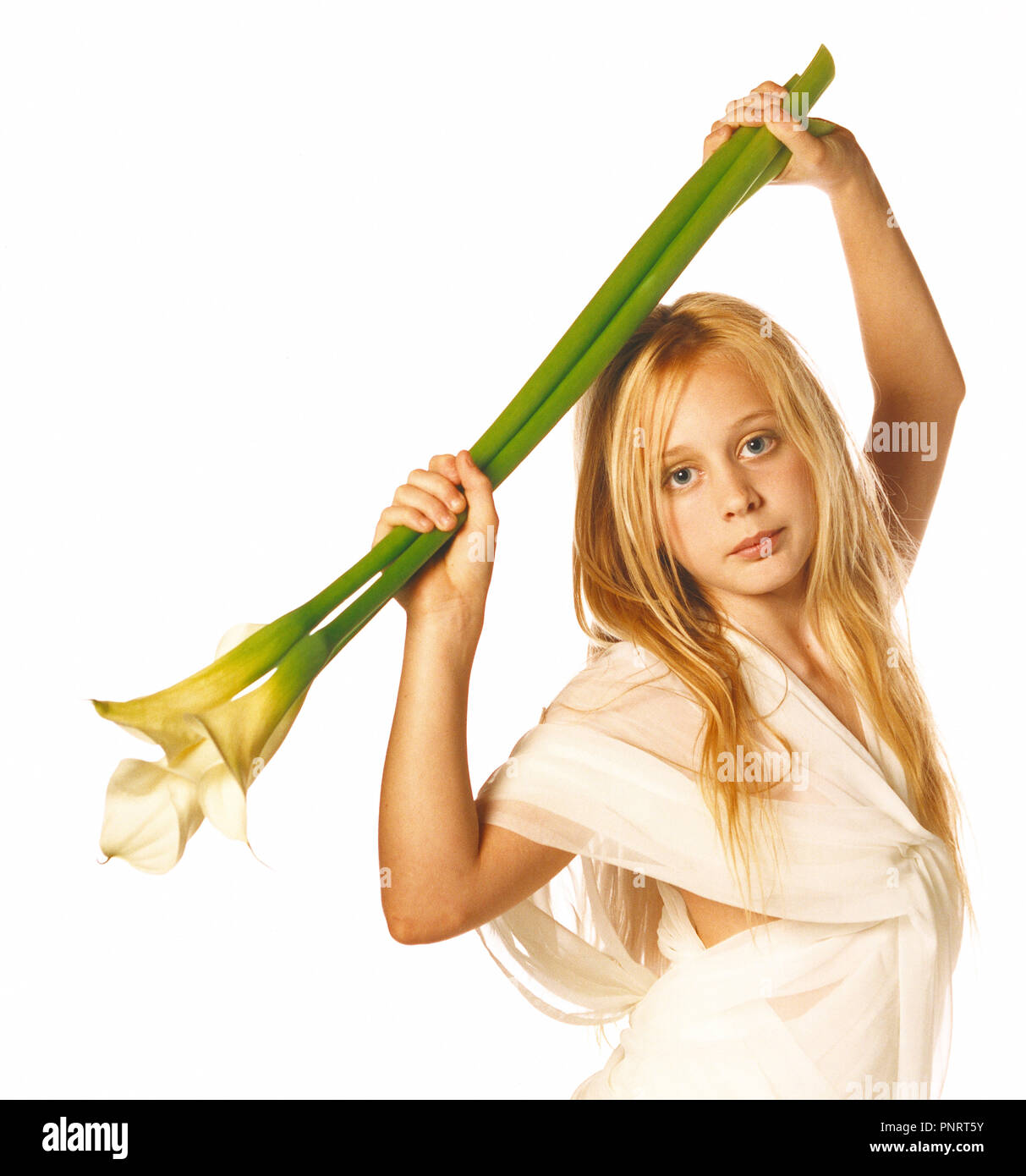 Children. Studio portrait of young blond hair girl holding a long-stemmed lwhite lily above her head. Stock Photo