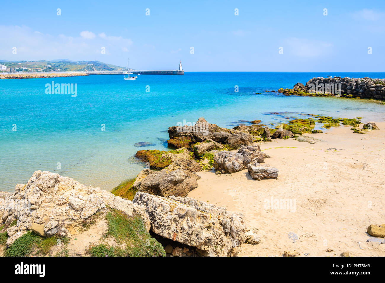 Rocks on sea coast and view of beach in Tarifa town, Costa de la Luz, Spain Stock Photo