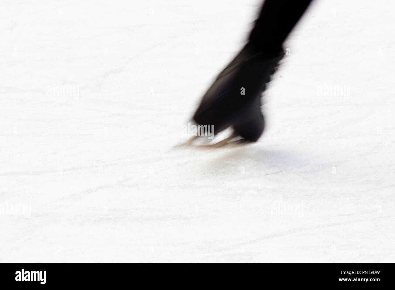 Blurry abstract ice skating shoe in action, close up Stock Photo