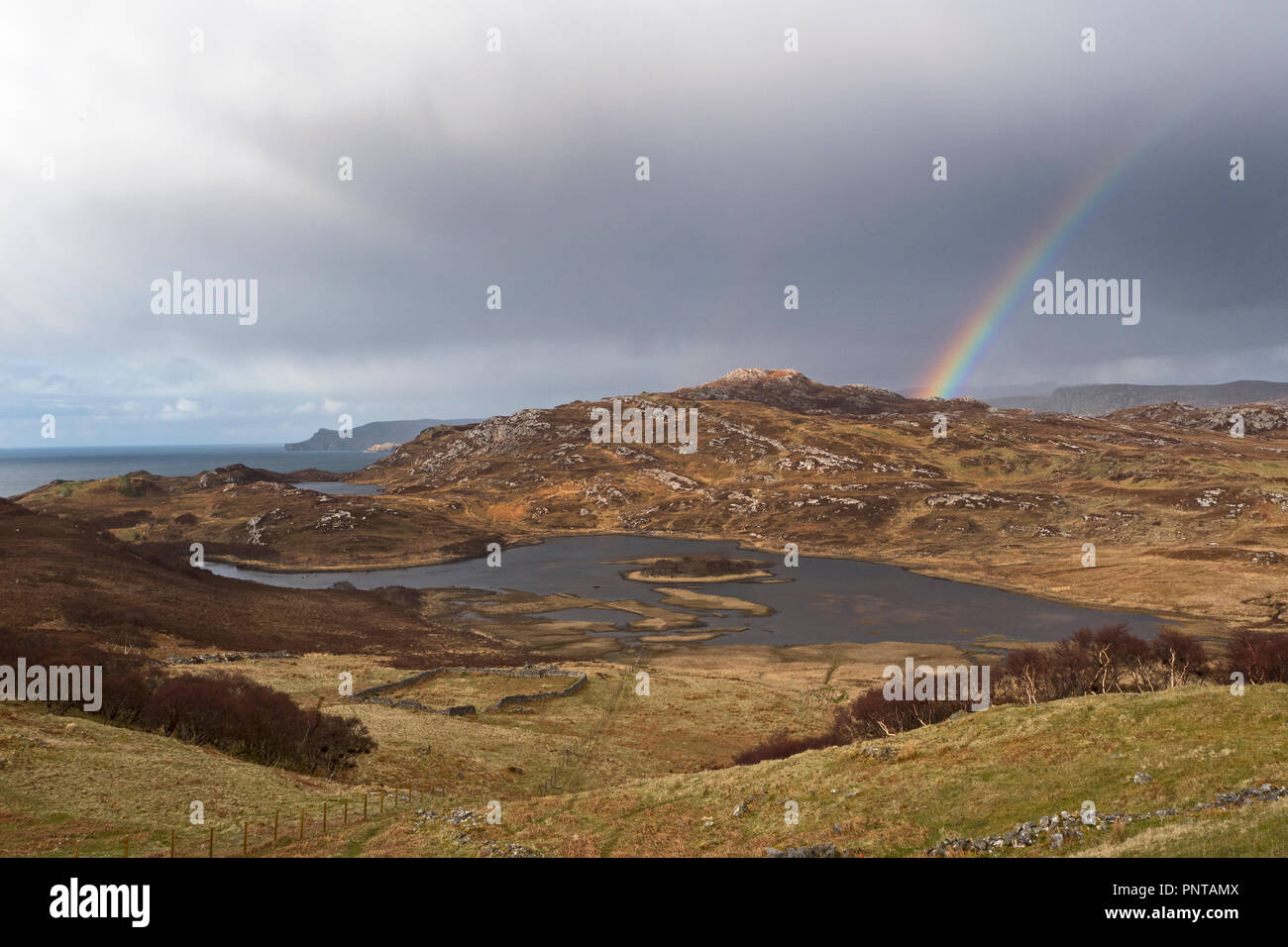 Rainbow over coast near Durness , Sutherland NW Scotland spring Stock Photo