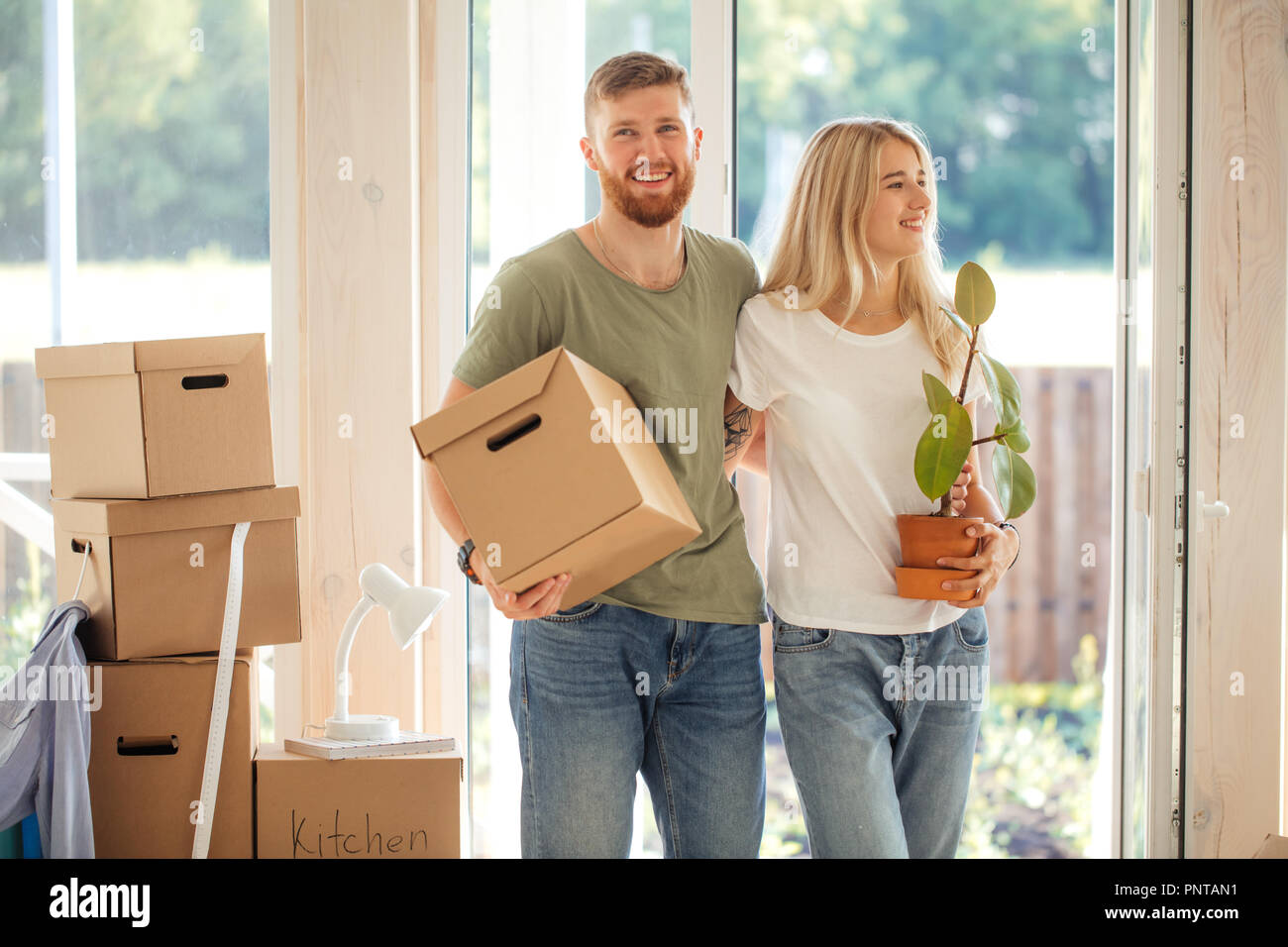 Happy Couple Carrying Cardboard Boxes Into New Home On Moving Day Stock ...