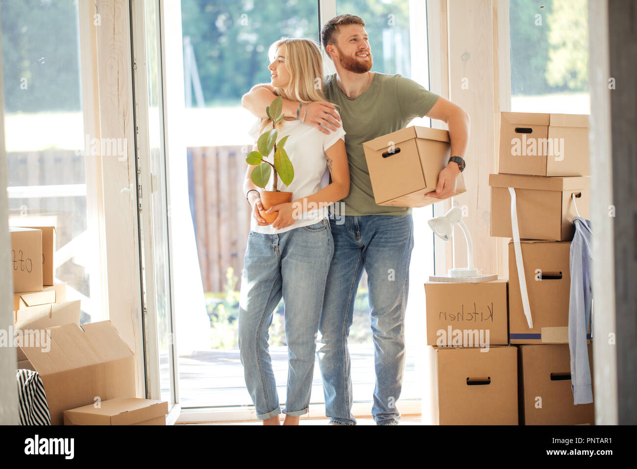 Happy Couple Carrying Cardboard Boxes Into New Home On Moving Day Stock ...