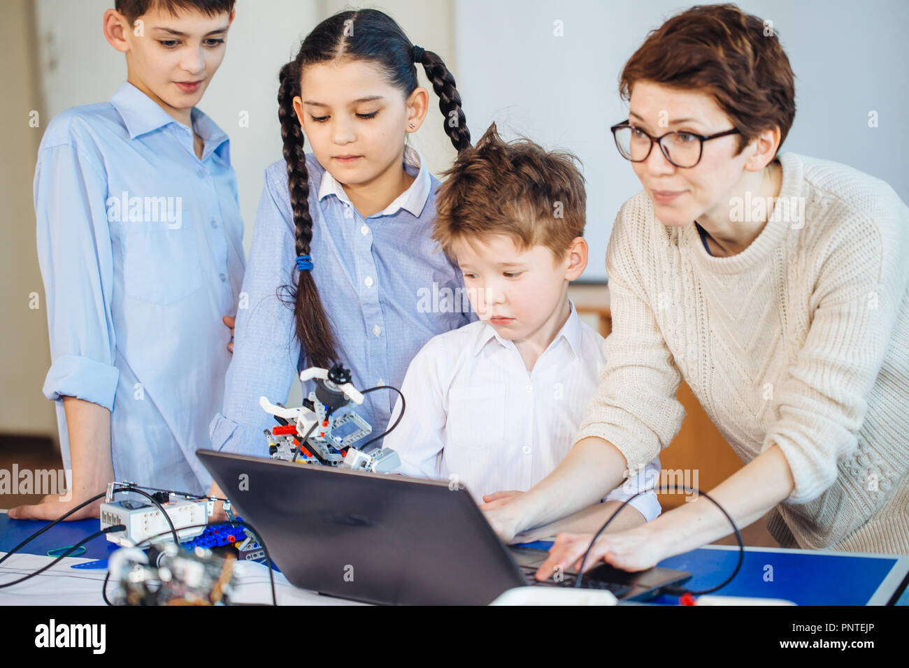 Happy children learn programming using laptops on extracurricular ...