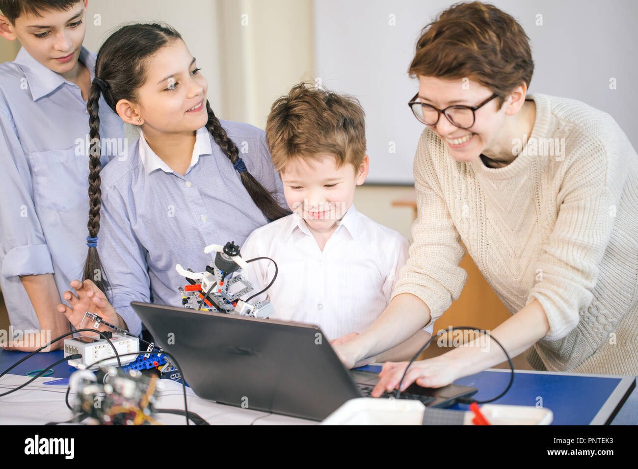 Happy children learn programming using laptops on extracurricular ...