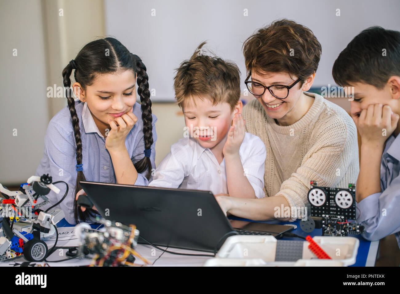 Happy children learn programming using laptops on extracurricular ...