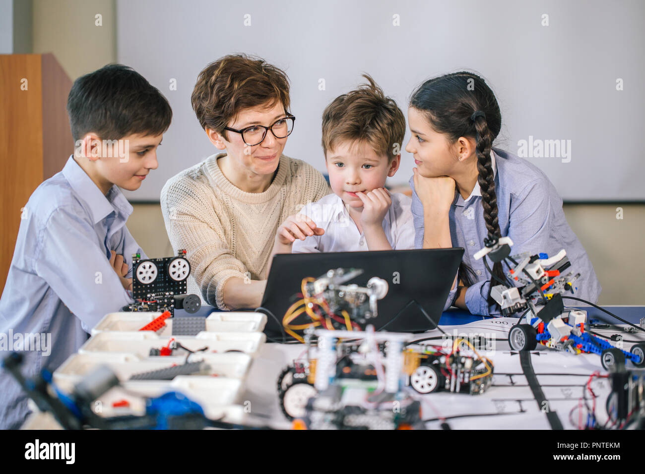 Happy children learn programming using laptops on extracurricular ...