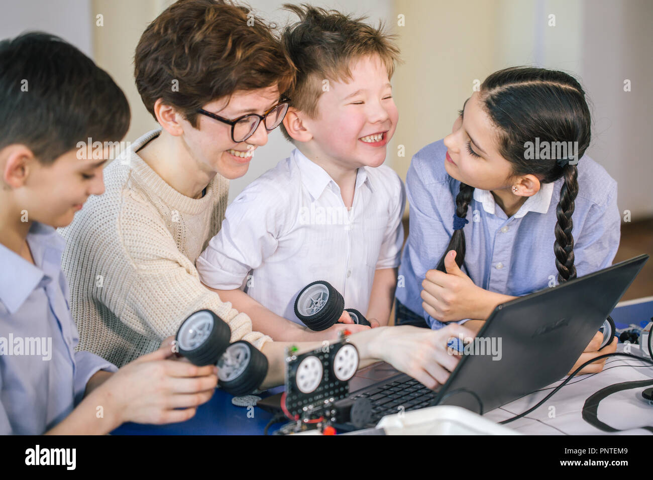 Happy children learn programming using laptops on extracurricular ...
