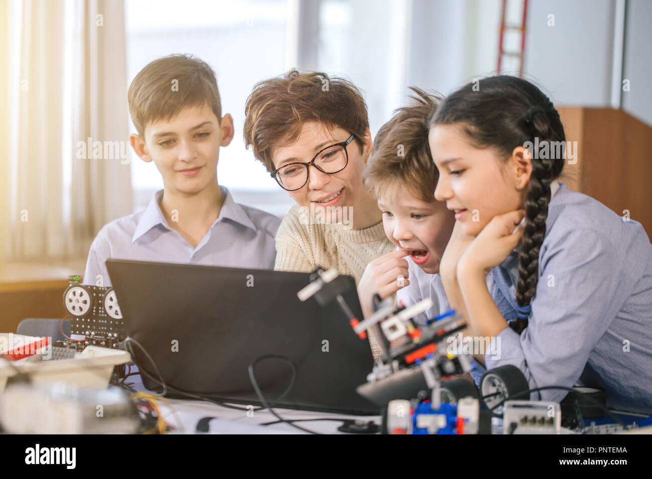 Happy children learn programming using laptops on extracurricular ...