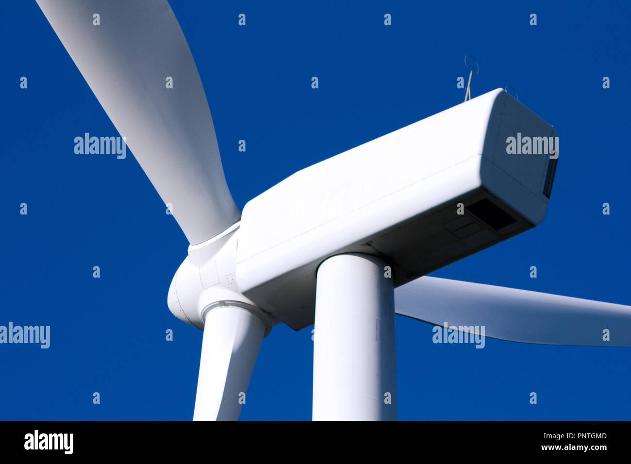 Pico Gallo, Tineo, Asturias. Back view of blades, rotor hub and full nacelle of a wind mill with dark blue sky. Stock Photo