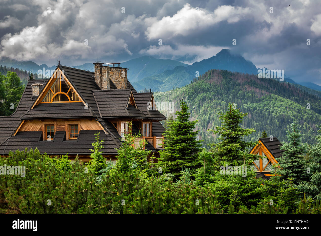 Clouds over Tatra Mountains and wooden cottage, Poland Stock Photo - Alamy