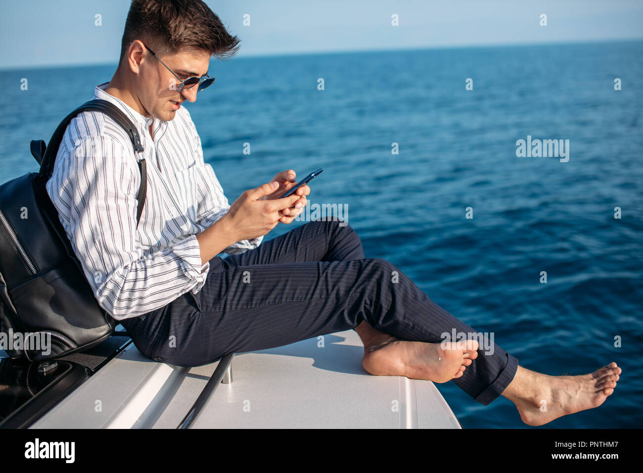 Handsome male model posing in front of a luxury yacht during summer  vacation Stock Photo - Alamy