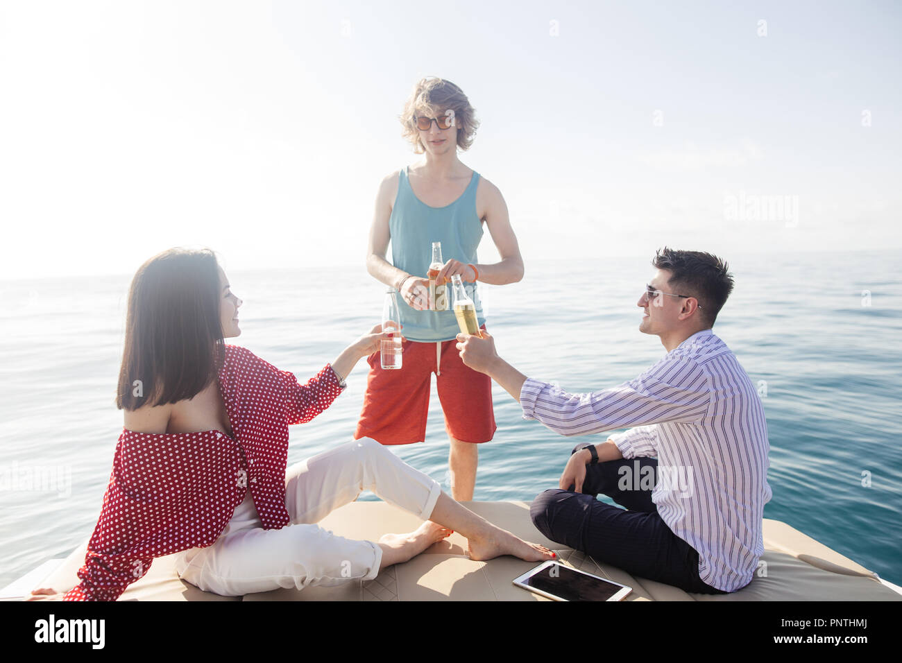 yacht drinking beers while talking Group of friends having party on