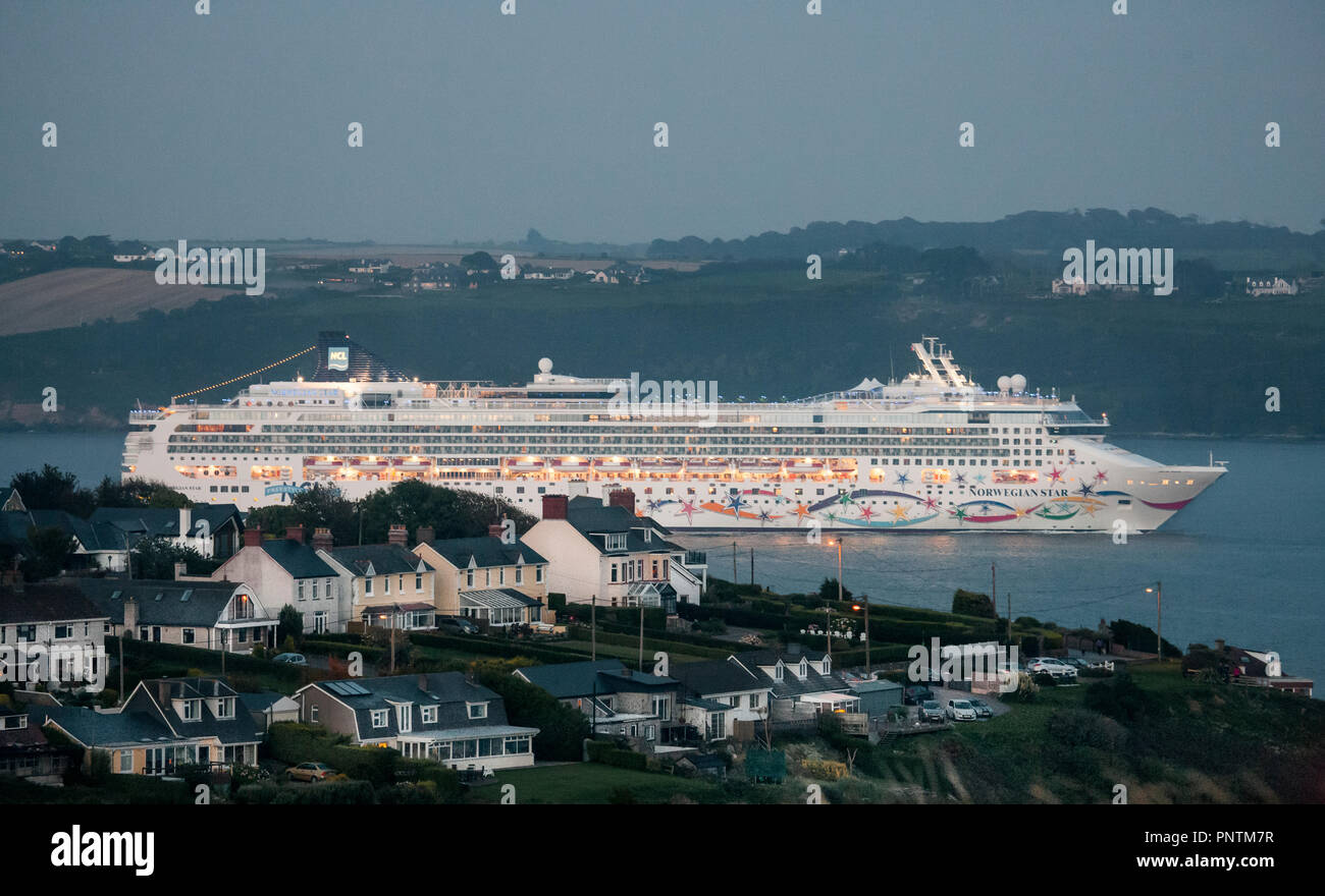 Church Bay, Cork, Ireland. 29th September 2015. Cruise liner Norwegian Star passes seafront homes as she makes her way out of the harbour at  Church B Stock Photo