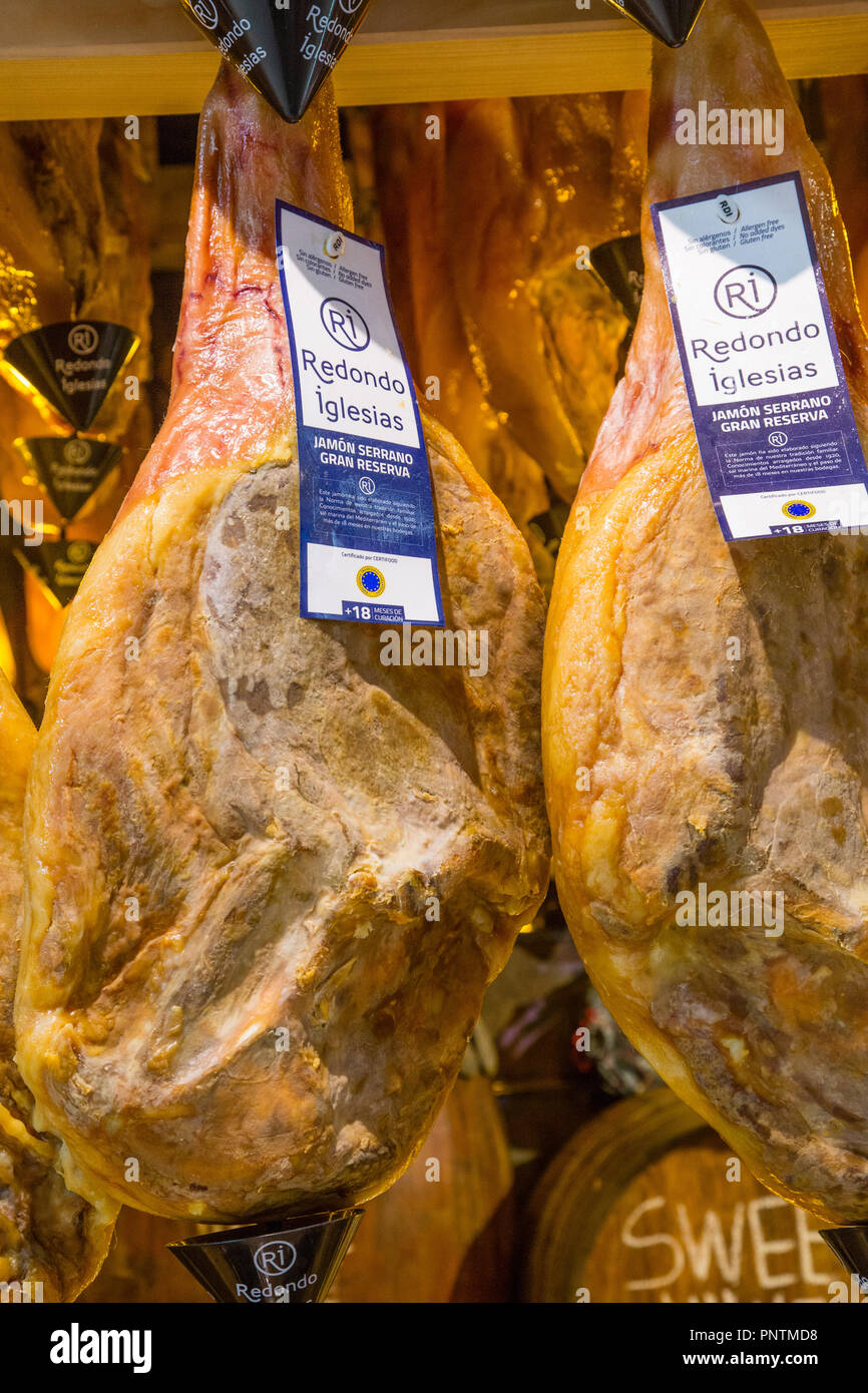 Serrano Ham legs hanging in Mercat Central, the central market in Valencia city, Spain Stock Photo