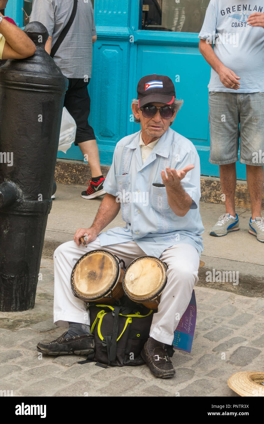 HAVANA, CUBA - JANUARY 16, 2017: Street musician perform for tourists and tips in Old Havana, Havana, Cuba Stock Photo