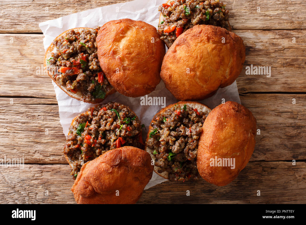 Fat Cake High Resolution Stock Photography And Images Alamy https www alamy com south africanvetkoekaka fat cake crispy outside and warm and fluffy inside filled with minced curry close up on the table horizontal top view from image219978275 html