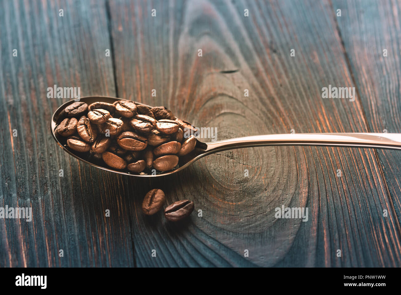 Spoon of coffee beans Stock Photo Alamy
