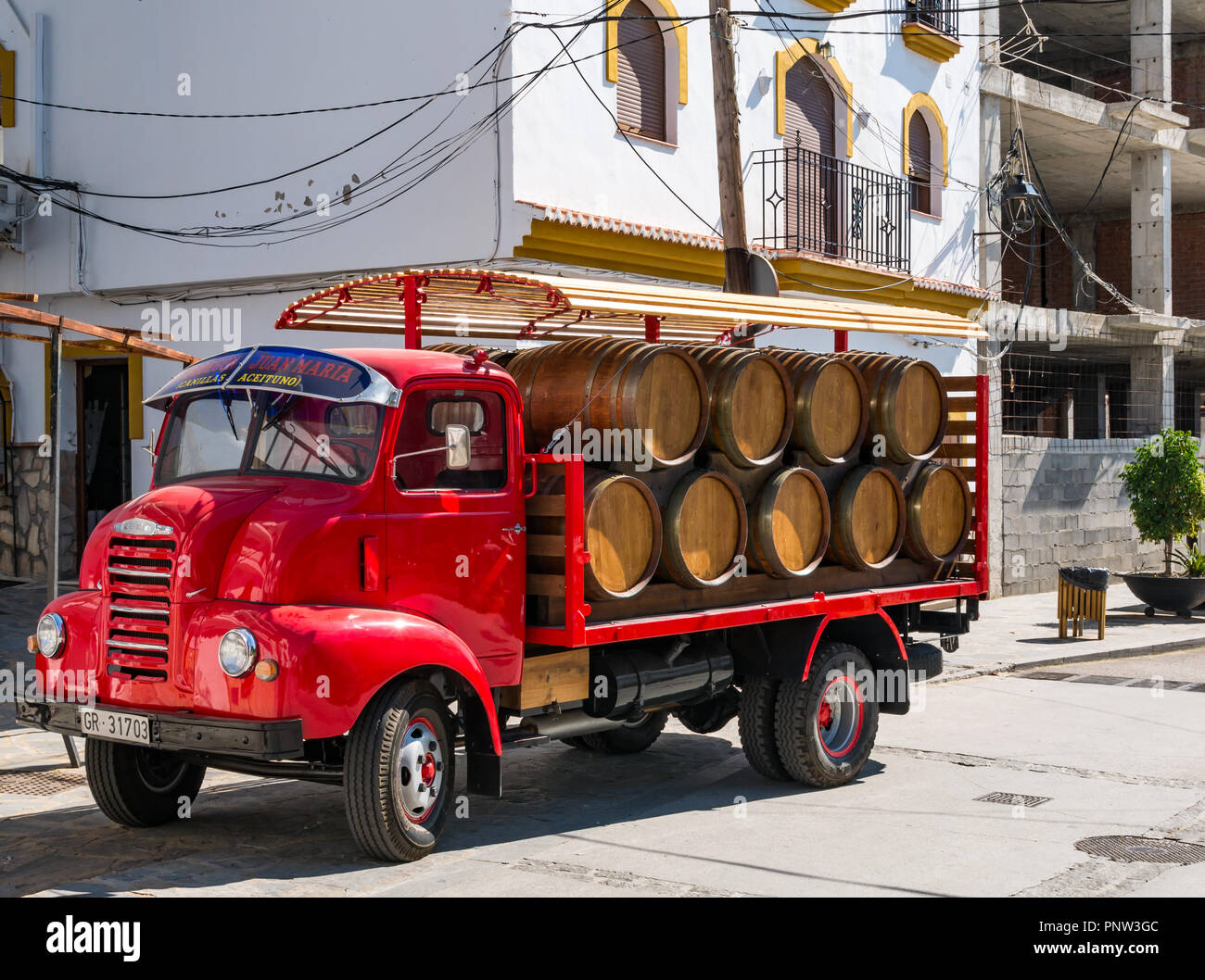 Wine barrels on old fashioned delivery lorry, El Bodegon de Juan Maria, Canillas de Acietuna, Axarquia, Andalusia, Spain Stock Photo
