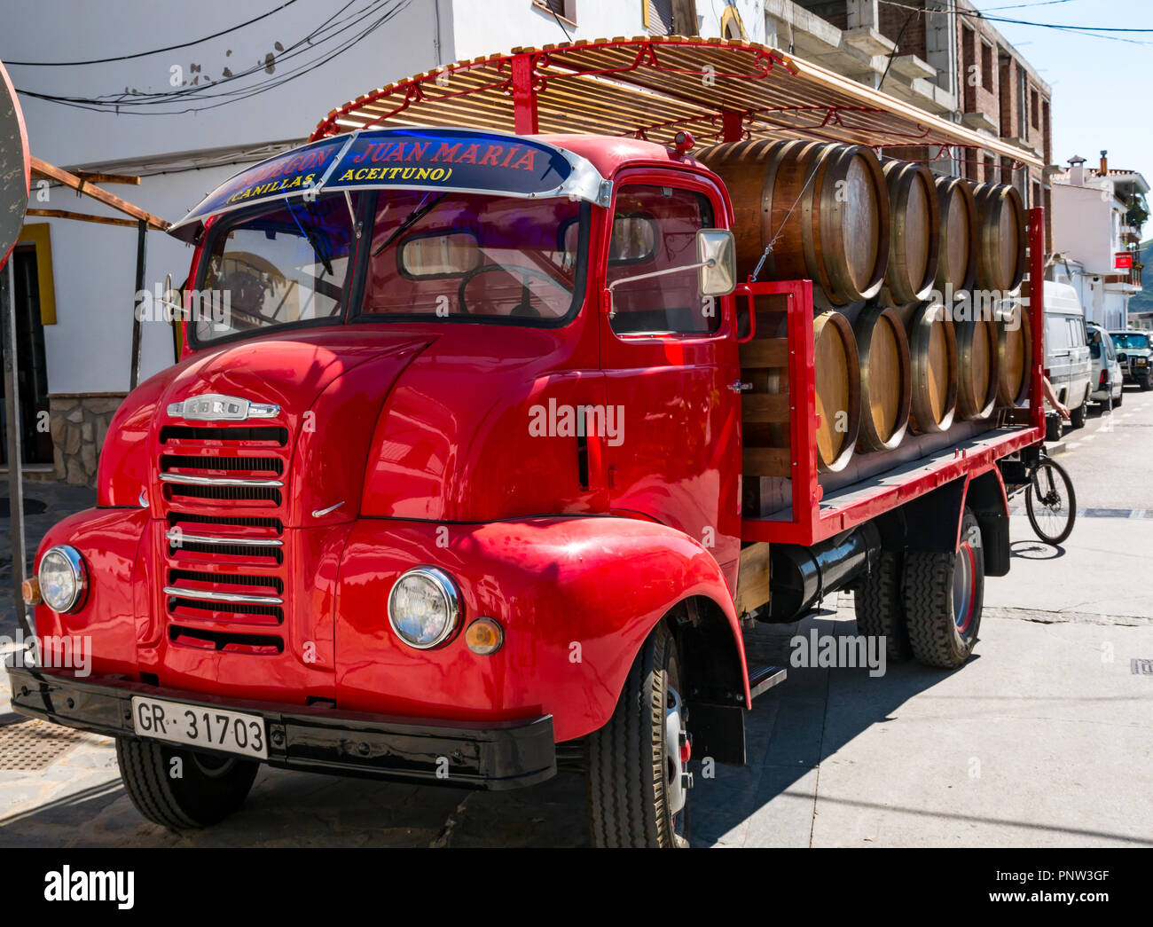 Wine barrels on old fashioned delivery lorry, El Bodegon de Juan Maria, Canillas de Acietuna, Axarquia, Andalusia, Spain Stock Photo