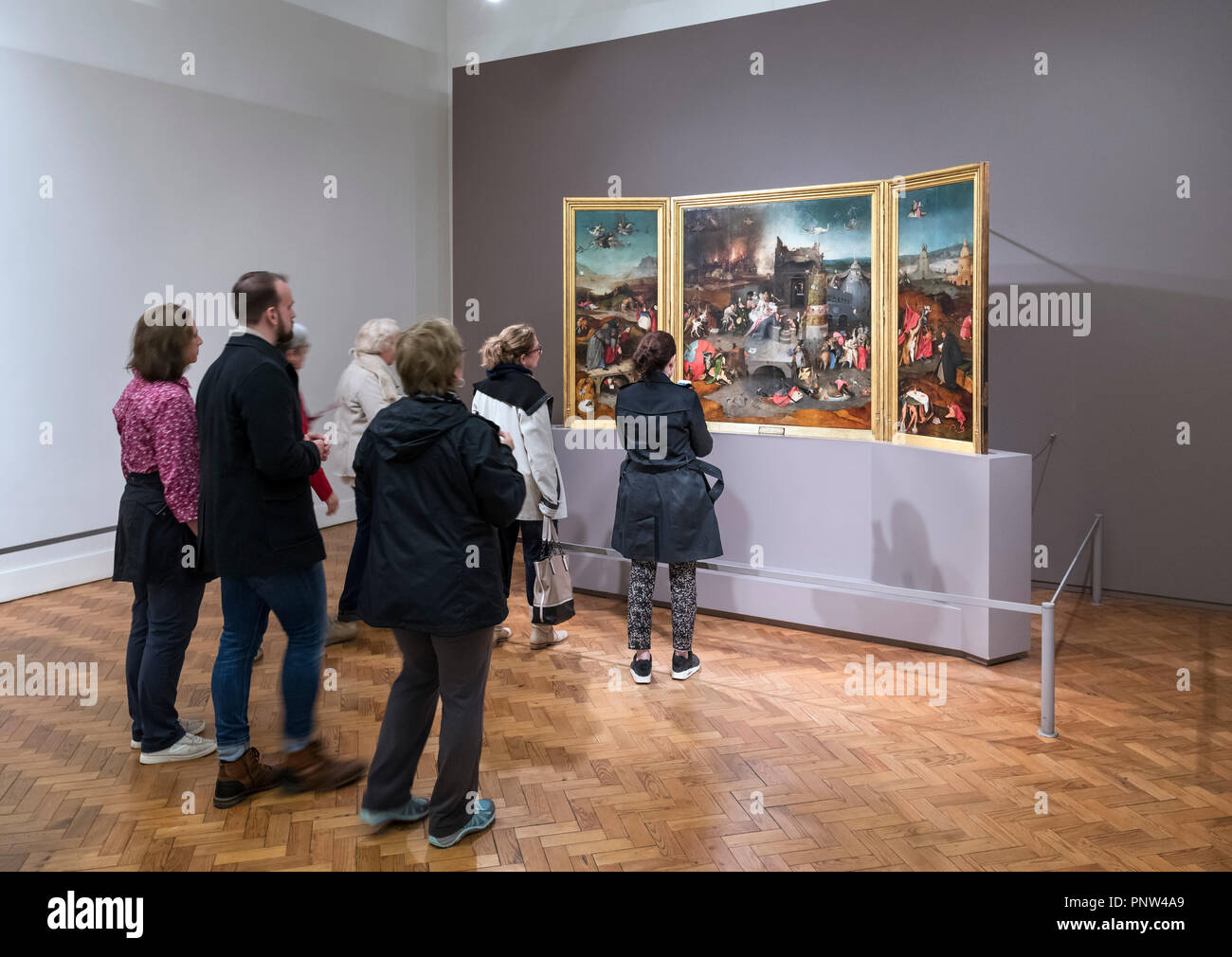 Visitors looking at the painting 'The Temptation of St Anthony' by Hieronymus Bosch, Museu Nacional de Arte Antiga, Lisbon, Portugal Stock Photo