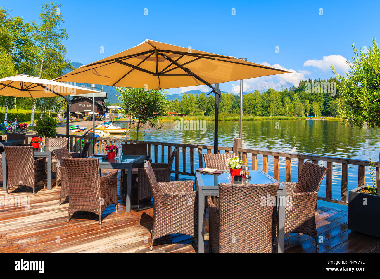 SCHWARZSEE LAKE, TIROL - AUG 3, 2018: Restaurant on promenade on shore of Schwarzsee lake near Kitzbuhel town on beautiful summer day, Austria. This p Stock Photo