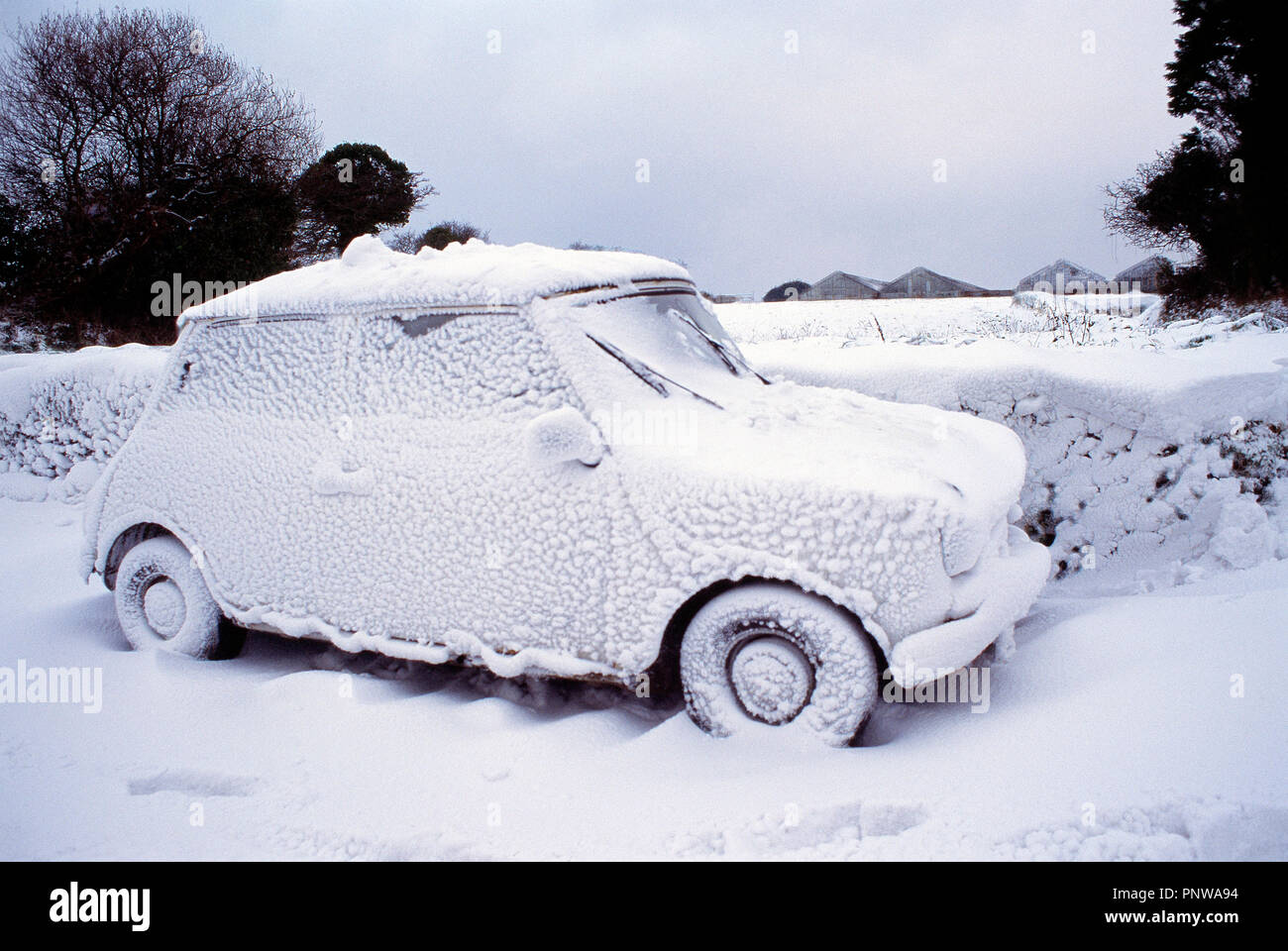 Winter scene with mini car covered in snow. Channel Islands. Guernsey. Stock Photo