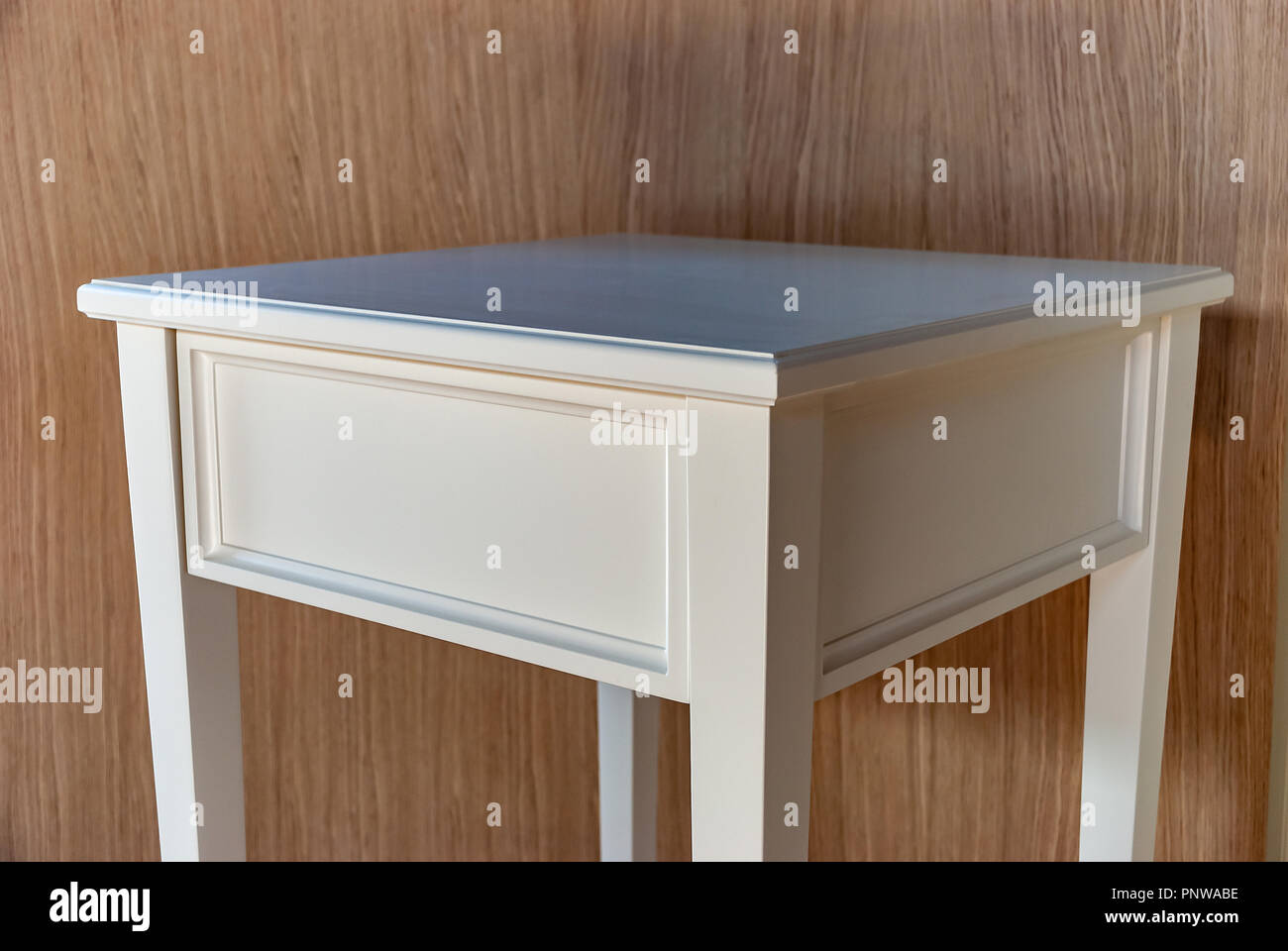 White bedside table in solid wood with drawer Stock Photo Alamy