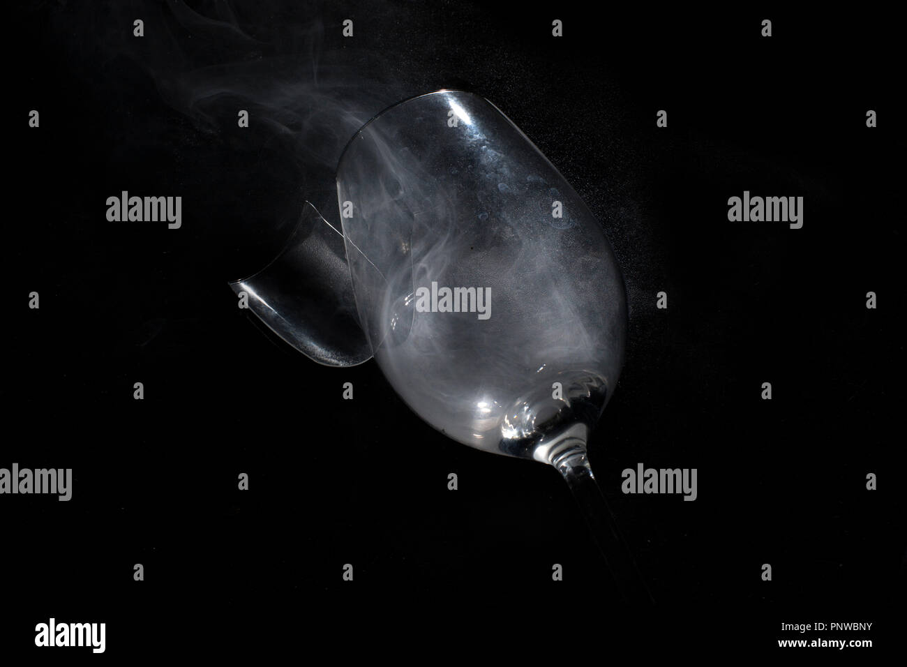 Broken wine glass, isolated on black background. Stock Photo