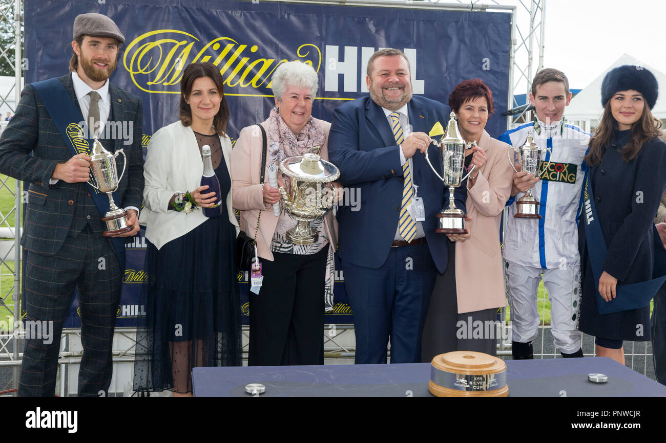 Jockey Hector Crouch (second right) and connections with the trophy after winning the William Hill Ayr Silver Cup Handicap Stakes onboard Snazzy Jazzy during William Hill Ayr Gold Cup Day at Ayr Racecourse. Stock Photo