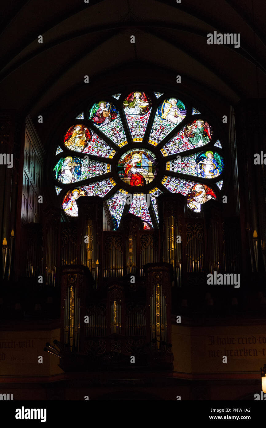 Stainedglass window depicting Saint Cecilia above the organ in the