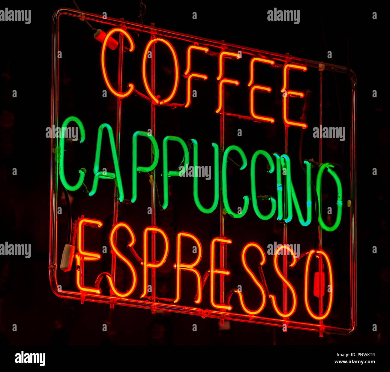 A neon sign in a cafe for differnt types of coffee on sale Stock Photo -  Alamy