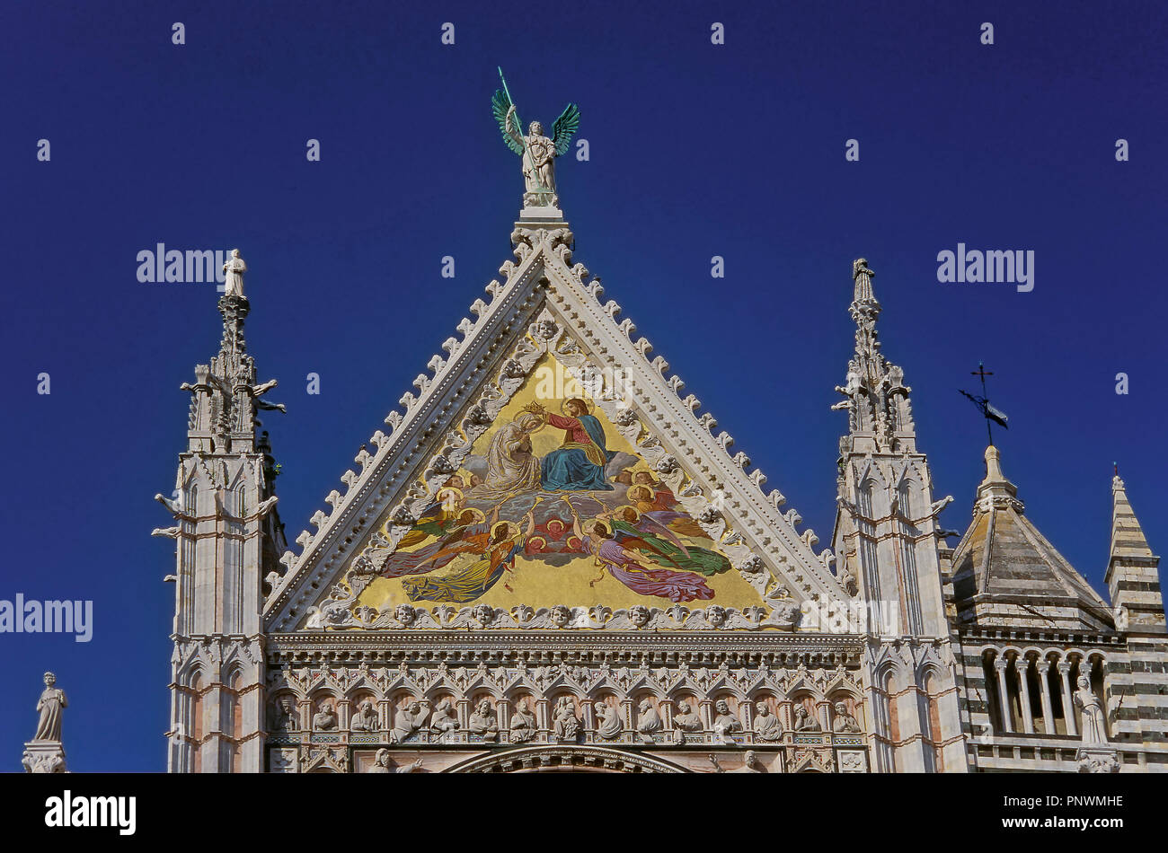 Cathedral of Santa Maria de la Asuncion. Venetian gold mosaic on the main pediment of the façade (Coronation of the Virgin by Luigi Mussini). Siena. I Stock Photo