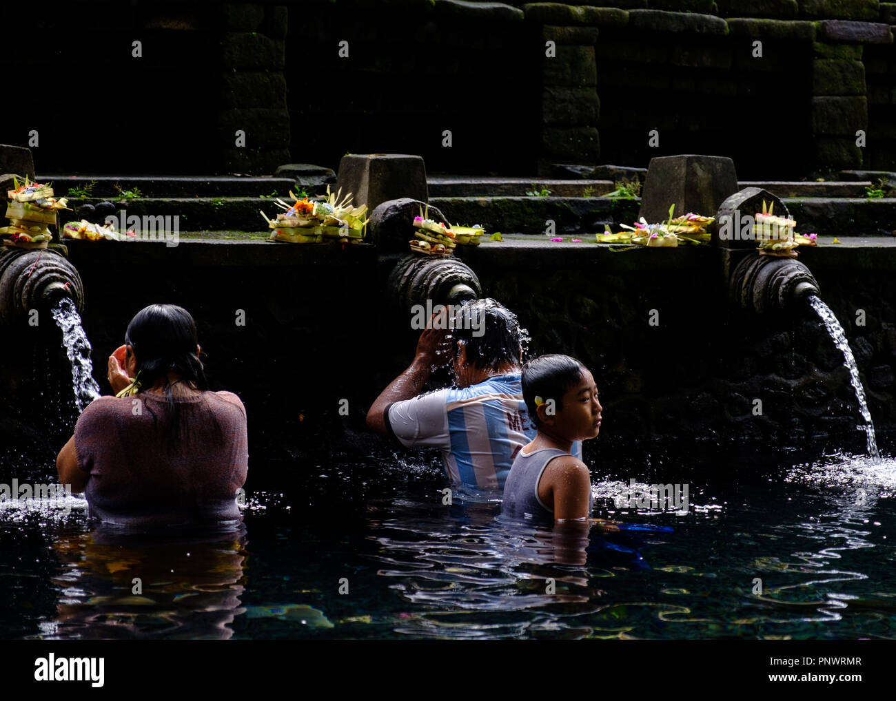 Balinese people taking a ritual purifying bath in holy spring water at